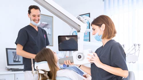 Female-dentist-scanning-patient's-teeth-with-x-ray-machine-at-modern-dental-clinic-16-9