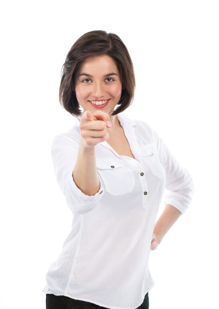 Portrait of a young woman pointing in front of her Focus on her face isolated on white